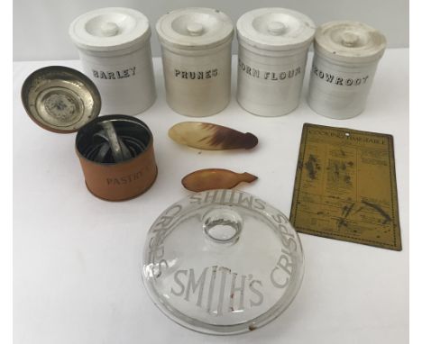 A box of vintage kitchenalia. To include: ceramic storage jars, a tin plate baking times sign, pastry cutters and a Smith's C