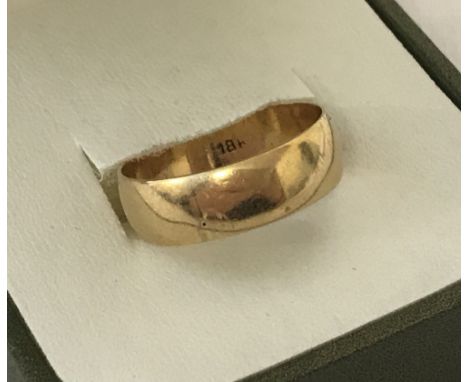 An 18ct gold 6mm wide wedding band. Total weight approx. 4.1g. Size O½.