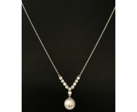 A modern elegant design diamond and pearl drop, 18ct white gold necklace by Luke Stockley. Single cultured pearl hanging from