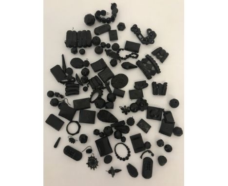 A collection of antique and vintage Whitby Jet beads, some with carved decoration.
