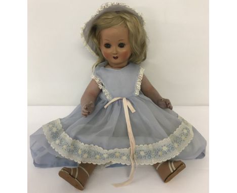 A 1930's ceramic fully jointed doll with flirty eyes. Red painted lips and finger &amp; toe nails with rouged cheeks. Real bl