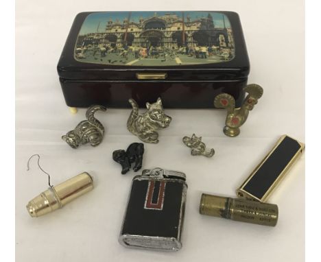A small vintage tourist musical box. Together with a small collection of metal animals and vintage lighters to include a Part