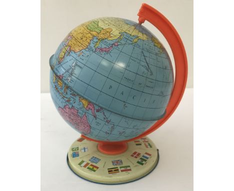 A tin plate Chad Valley political globe (revised 1976).On a cream tin base depicting national flags.