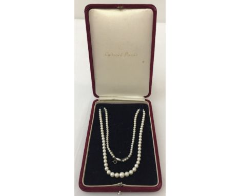 A string of vintage cultured pearls with 9ct white gold clasp. In original box. Clasp Marked Ciro 9ct. Approx 18 inches long.