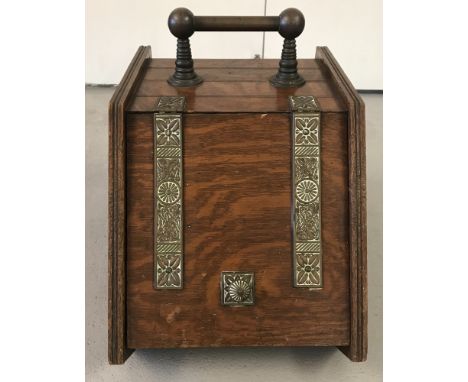 A vintage wooden coal scuttle with brass banding with floral decoration. Complete with original aluminium liner.