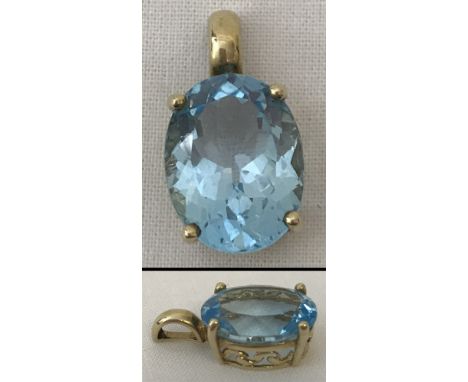 A 9ct gold pendant set with a large oval blue topaz stone. Pierced work to sides of mount. Stone approx. 16mm x 11mm.