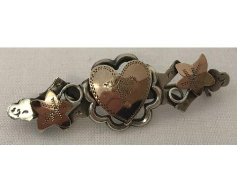 An antique silver and rose gold sweetheart brooch with ivy leaf and central heart decoration. Hallmarked Ward Brothers, Chest