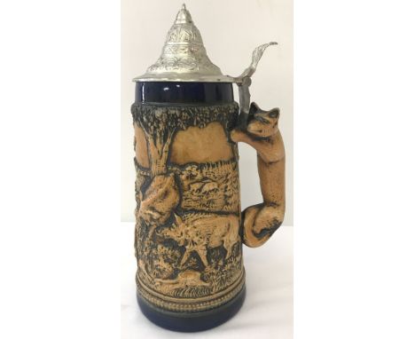 A large ceramic lidded stein with animal scene and fox shaped handle. Waidmanns Heil "Good Hunting" inscription. Overall heig