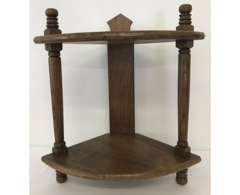 A vintage medium oak 2 tier corner shelf with turned detail to columns. Approx. 50cm tall.