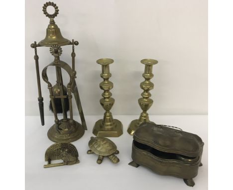 A collection of brass items.To include a vintage tea caddy, pair of candlesticks and a companion set.