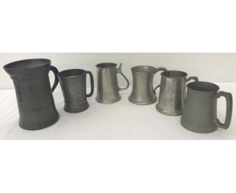 A Victorian pewter quart measure. Together with a Victorian pewter pint tankard and 4 other vintage pewter tankards.