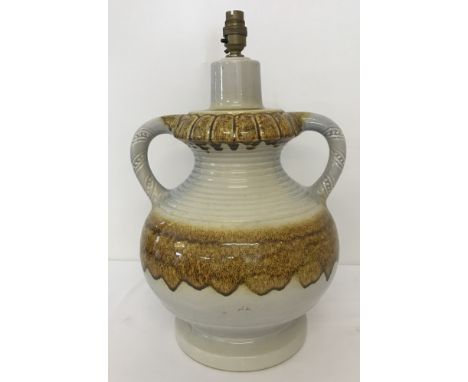 A large German ceramic 2 handled lamp base. Cream coloured with brown drip glaze design. Approx. 46cm tall.