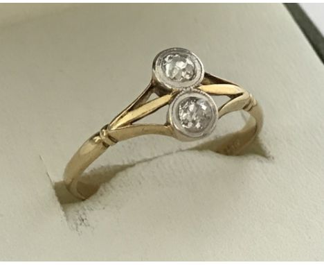 A ladies 18ct gold and platinum 2 diamond set dress ring. Front and back set round cut diamonds, each stone is .15 carat, tot