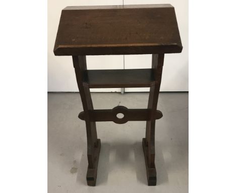 A vintage solid oak lectern with undershelf and circular cut outs to sides and stretcher.Approx. 81cm x 45cm.