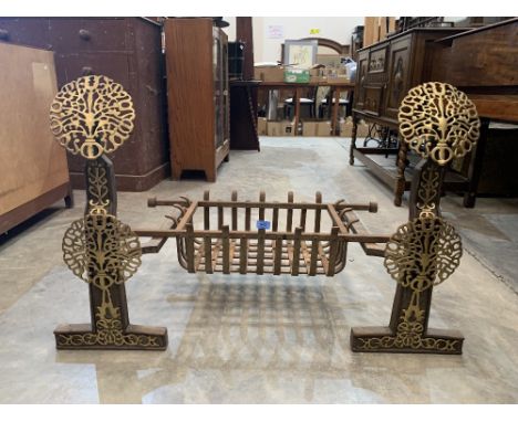 A pair of iron and brass applied fire dogs with grate, the dogs 27' high. Prov: Commissioned by Lord and Lady Inchiquin for t