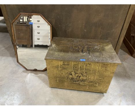An octagonal shell moulded wall mirror with bevelled plate and a brass embossed log box