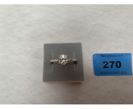 A diamond solitaire ring. In gold marked 750. 4g gross. Size R. The stone 6mm diam. x 3.5m deep approx.