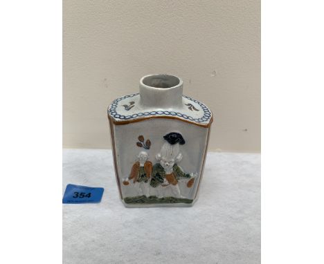 A 19th century tea caddy, moulded with figures in low relief. 4¾' high