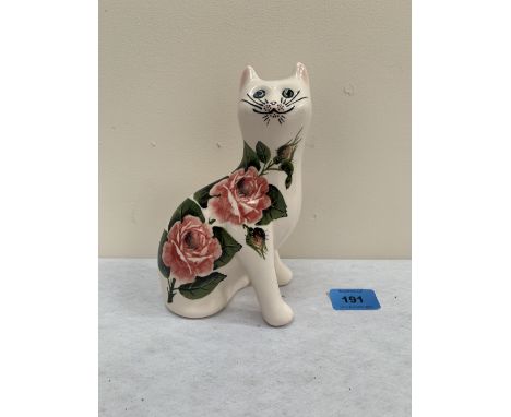 A Griselda Hill Pottery Wemyss Ware white cat, painted with pink roses, signed to base. 7¼' high