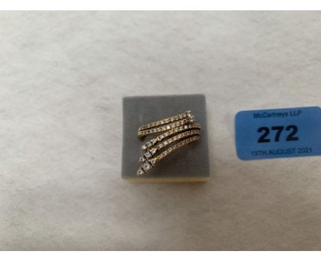 A modernist design diamond ring. In gold marked 750. 10g gross. Size T