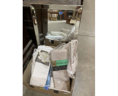 A box of bed linen and a wall mirror