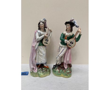 A pair of 19th century Staffordshire figures, gentleman with lute and lady companion. 10' high