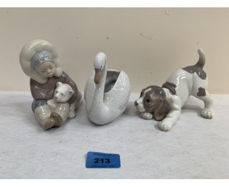 A Lladro puppy; a Lladro inuit child with polar bear cub and a Nao sawn (3)