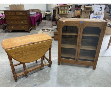 A light oak dropleaf table and an oak glazed bookcase