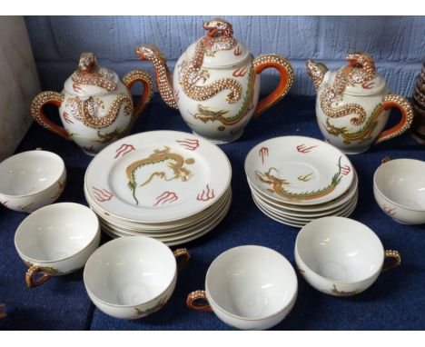 Mid-20th century Japanese porcelain tea set, the cups with a lithophane of a geisha girl in the base, the tea pot, sugar bowl