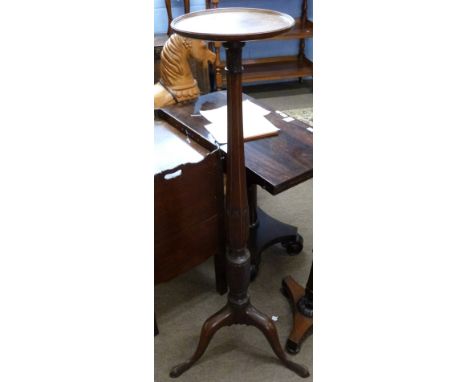 Early 20th century mahogany torchere with plain circular top, bulbous carved panelled column with wrythen detail above a trip