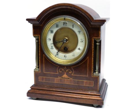 Edwardian mantel clock, the wooden case with inlay decoration, the dial flanked by two small metal pillars, 23cm high