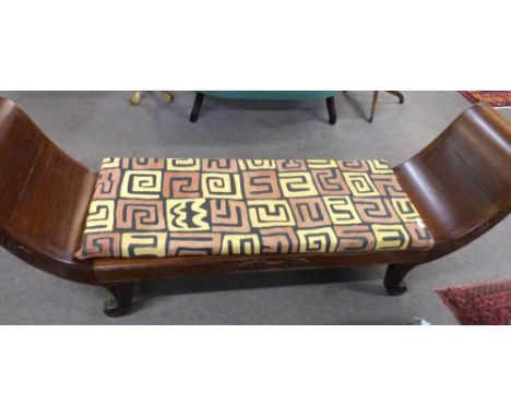 20th century Far Eastern hardwood bench seat with double scrolled ends, raised on four carved scrolled feet, plus loose cushi