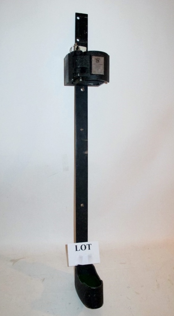 A wall mounted single shotgun holder/safe with key made by Smith