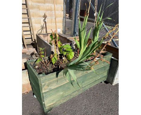 Wooden trough planter including plants