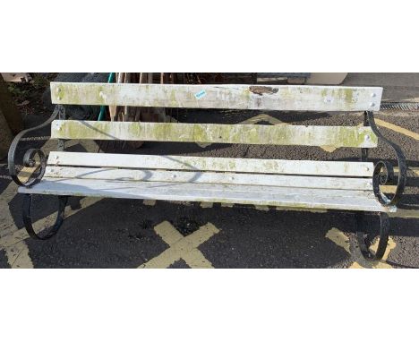 Wrought iron framed garden bench with white painted wooden slats