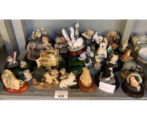 Collection of ceramic animals on wooden bases