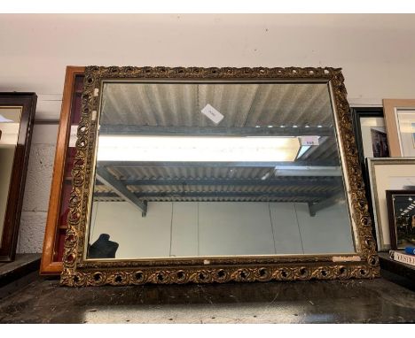 Gilt frame wall mirror and a display case of spoons