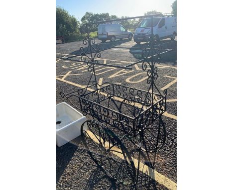 An iron garden planter in the form of a trolley