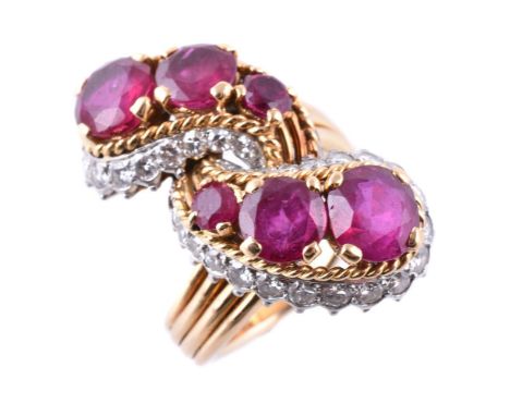 A 1960s French ruby and diamond crossover ring, set with graduating circular cut rubies in ropetwist settings to brilliant cu