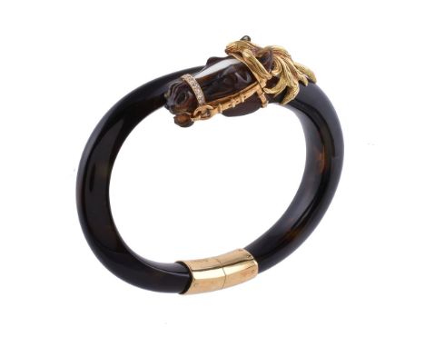 ϒA 1960s French tortoiseshell and diamond bangle by Fred, the carved tortoiseshell horse head with a gold mane and bridle, th