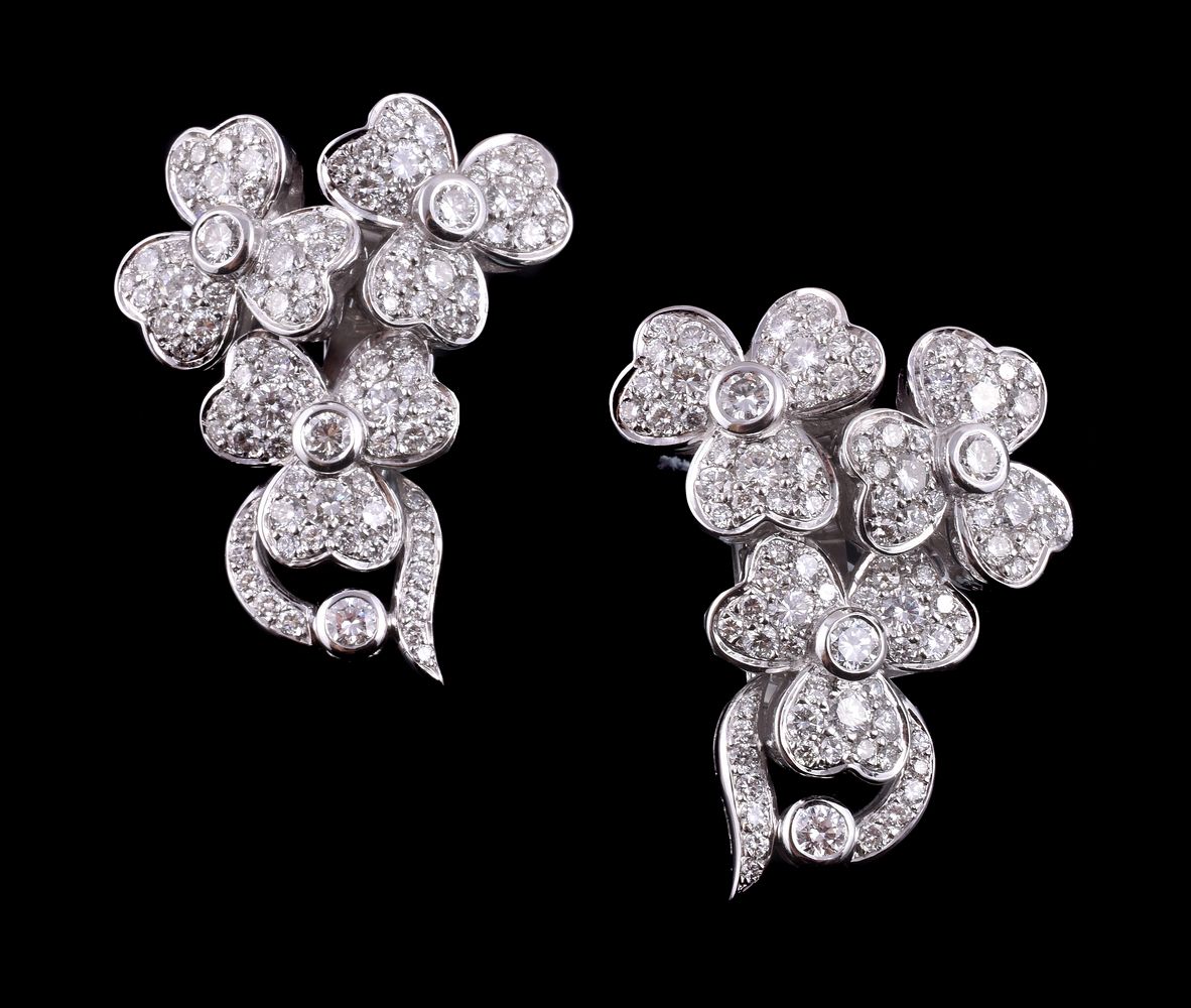 A pair of diamond floral spray earrings, the earrings each composed of