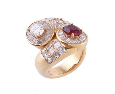 A ruby and diamond dress ring, the crossover ring set with an oval cut ruby estimated to weigh 1.60 carats, and an oval cut d