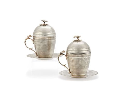 A pair of Ottoman silver parcel gilt sahlep cups, covers and stands, Tughra and sah marks, probably Egyptian, late 19th centu