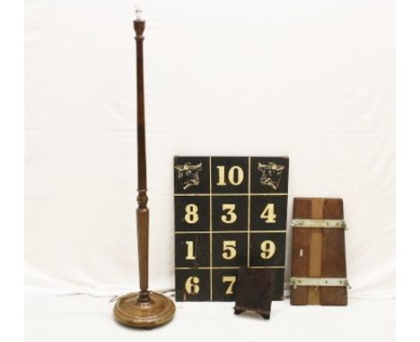 A numbered game board, a vintage trouser press, a tall lamp stand and a book stand