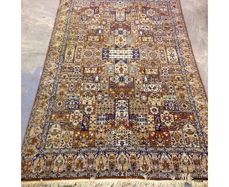 A small carpet with squares on a brown background 220 x 140cm