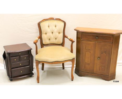 An upholstered button back chair, a 1 drawer cupboard unit, a 5 drawer chest of drawers/magazine rack