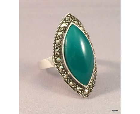 A silver and jade marcasite dress ring