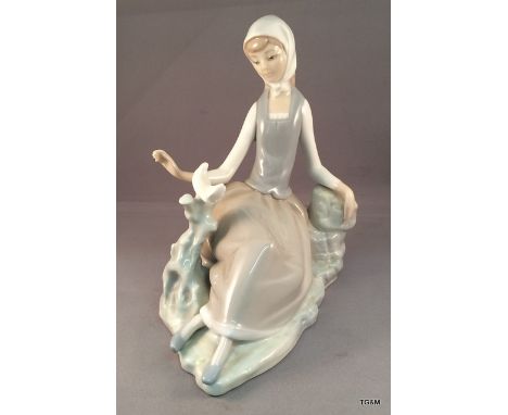 A lladro lady sitting with ducks