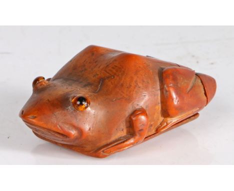 A charming and large coquilla gentleman's snuff box, circa 1800Designed as a frog, set with glass eyes, the back legs flankin