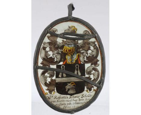 A 17th Century stained glass panel, dated 1675, with a coat of arms and the script Mr Robertus Schorer Schoudt yab slants-vie